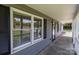 Inviting front porch with gray siding, black shutters, and white railings at 1228 Swift Rd, Oakboro, NC 28129