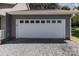 Attached garage featuring a white door and nine windows above at 1228 Swift Rd, Oakboro, NC 28129