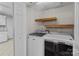 Convenient laundry room features shelving and modern washer and dryer appliances at 1228 Swift Rd, Oakboro, NC 28129