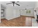 Bright and open living space with hardwood floors and a decorative white brick fireplace feature at 1228 Swift Rd, Oakboro, NC 28129