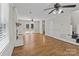 Bright living room with hardwood floors, white brick fireplace, and a door to the rear deck at 1228 Swift Rd, Oakboro, NC 28129