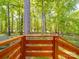 A wooden railing overlooks a lush, green backyard full of trees at 1241 Pitts Rd, Chester, SC 29706