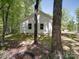 The rear of the home has classic white siding and simple landscaping at 1241 Pitts Rd, Chester, SC 29706