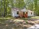 A quaint, single-story home featuring a inviting front porch with natural wood features and green lawn at 1241 Pitts Rd, Chester, SC 29706