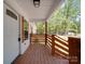 Inviting front porch with natural wood railing, door, and trim, perfect for relaxing outdoors at 1241 Pitts Rd, Chester, SC 29706