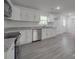 Contemporary kitchen featuring gray granite countertops, white cabinets, and stainless steel appliances at 1241 Pitts Rd, Chester, SC 29706