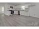 Modern kitchen with white cabinets, stainless steel appliances, and durable light gray flooring at 1241 Pitts Rd, Chester, SC 29706