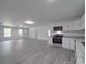 Expansive view of the open-concept kitchen and living room, showcasing gray flooring and natural light at 1241 Pitts Rd, Chester, SC 29706