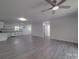 Bright and airy living room open to kitchen, featuring wood flooring and a modern ceiling fan at 1241 Pitts Rd, Chester, SC 29706