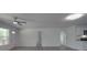 Bright, open living room features modern gray flooring, ceiling fan and access to the front door at 1241 Pitts Rd, Chester, SC 29706