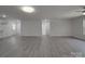 Open-concept living room with light gray flooring, ceiling fan, and access to other rooms at 1241 Pitts Rd, Chester, SC 29706