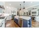 Open kitchen with island, stainless steel appliances, hardwood floors, and farmhouse sink at 125 Swayne Dr, Mooresville, NC 28117