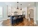 Modern kitchen with island, stainless steel appliances, pendant lighting and hardwood floors at 125 Swayne Dr, Mooresville, NC 28117