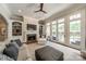 Bright living room with fireplace, built-in shelves, and access to the outdoor patio at 125 Swayne Dr, Mooresville, NC 28117