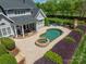 Backyard featuring a pool, stone hot tub, outdoor fireplace and a covered lounge area at 125 Swayne Dr, Mooresville, NC 28117