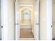 Arched doorway leading to a tub and window in an all-white bathroom design at 126 Dairy Farm Rd, Mooresville, NC 28115
