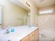Bright bathroom featuring double sinks, a large mirror and a tub/shower combo at 126 Dairy Farm Rd, Mooresville, NC 28115