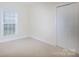 Neutral-toned bedroom with a double door closet and a window with blinds at 126 Dairy Farm Rd, Mooresville, NC 28115