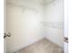 Bright walk-in closet featuring white wire shelving and neutral carpeting at 126 Dairy Farm Rd, Mooresville, NC 28115