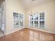 Bright dining room featuring hardwood floors, large windows, and an elegant chandelier at 126 Dairy Farm Rd, Mooresville, NC 28115