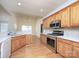 Well-equipped kitchen with stainless steel appliances, wooden cabinets, and quartz countertops at 126 Dairy Farm Rd, Mooresville, NC 28115