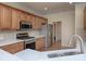 Well-equipped kitchen featuring stainless steel appliances, wood cabinets, and updated countertops at 126 Dairy Farm Rd, Mooresville, NC 28115