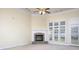 Comfortable living room featuring a fireplace with stone accents, ceiling fan, and large windows at 126 Dairy Farm Rd, Mooresville, NC 28115