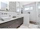 Bright, updated bathroom with double sinks, modern tile work, and a glass-enclosed shower at 1416 S Church St, Charlotte, NC 28203
