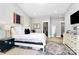 Bright bedroom features a plush bed, neutral decor, and a walk-in closet at 1416 S Church St, Charlotte, NC 28203