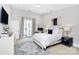 Comfortable bedroom with a queen-sized bed, desk, and balcony access through sliding glass doors at 1416 S Church St, Charlotte, NC 28203