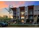 Beautiful modern townhome with multiple balconies and manicured landscaping under a colorful twilight sky at 1416 S Church St, Charlotte, NC 28203