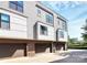 Modern townhouse with brick and siding, featuring multiple windows and garage doors, with well-kept landscaping at 1416 S Church St, Charlotte, NC 28203
