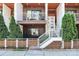 A close-up of a modern townhome entrance featuring a white staircase and attractive landscaping at 1416 S Church St, Charlotte, NC 28203