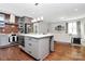 Modern kitchen island with an adjacent stainless steel refrigerator and open living area at 1416 S Church St, Charlotte, NC 28203