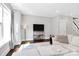 Bright living room featuring hardwood floors, large windows and a comfortable sectional couch at 1416 S Church St, Charlotte, NC 28203