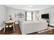 Living room with hardwood floors, a comfortable couch, and decoratively framed pictures on the wall at 1416 S Church St, Charlotte, NC 28203