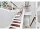 Modern staircase with hardwood steps and white railing, connecting multiple floors of the home at 1416 S Church St, Charlotte, NC 28203