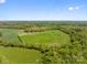 Beautiful aerial view of the property showcasing lush green fields and surrounding trees at 15670 Bethel Avenue Ext, Midland, NC 28107