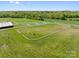 Aerial shot of horse paddocks with white fencing and green pastures on a well-maintained farm at 15670 Bethel Avenue Ext, Midland, NC 28107