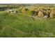Scenic aerial view of farm with manicured fenced pasture and outbuildings at 15670 Bethel Avenue Ext, Midland, NC 28107
