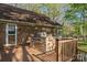 Outdoor wooden deck features a stone built-in grill, offering space for outdoor cooking and entertaining at 15670 Bethel Avenue Ext, Midland, NC 28107