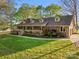 Charming brick home featuring a welcoming front porch, manicured lawn, and mature landscaping at 15670 Bethel Avenue Ext, Midland, NC 28107
