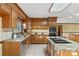 Bright kitchen featuring a kitchen island, custom cabinets, granite countertops, and stainless steel appliances at 15670 Bethel Avenue Ext, Midland, NC 28107