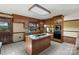 Cozy kitchen with custom cabinets, granite countertops, tiled floor, and stainless steel appliances at 15670 Bethel Avenue Ext, Midland, NC 28107
