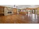 Spacious living room featuring a stone fireplace, hardwood floors, and built-in wooden shelving at 15670 Bethel Avenue Ext, Midland, NC 28107