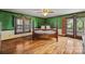 Comfortable bedroom with hardwood floors, natural light from windows, and ensuite bathroom access at 15670 Bethel Avenue Ext, Midland, NC 28107