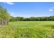 Open pasture with a wooden fence under a blue sky, showcasing the property's serene landscape at 15670 Bethel Avenue Ext, Midland, NC 28107