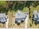 Aerial view of a home showcasing its well-maintained yard, patio area, and proximity to mature trees and neighboring houses at 164 Riverstone Dr, Davidson, NC 28036