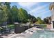Beautiful backyard with a hot tub, seating, green grass, and mature trees at 164 Riverstone Dr, Davidson, NC 28036