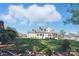Spacious backyard featuring lush green grass, mature trees, and a screened porch, perfect for outdoor entertaining at 164 Riverstone Dr, Davidson, NC 28036